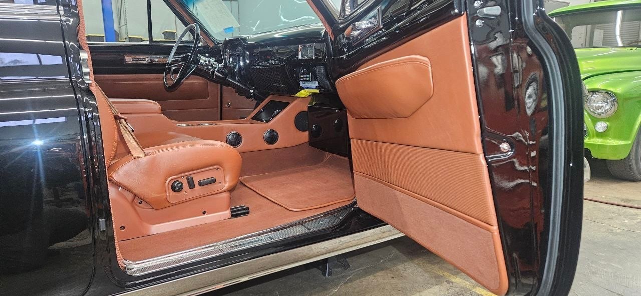Cognac leather seat, console and door panel in a black Cadillac