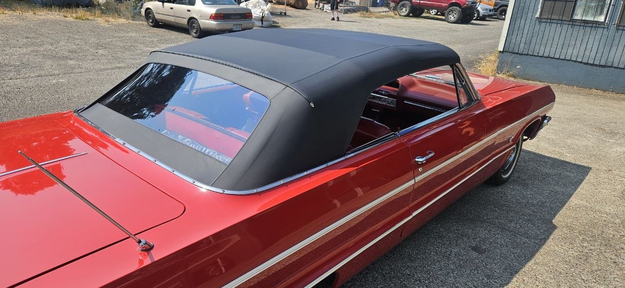 New black convertible top on a red classic convertible